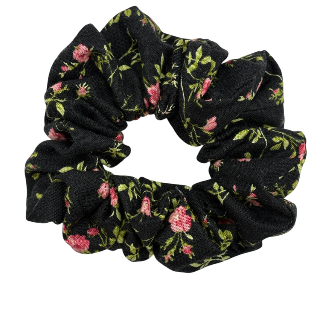 Black floral scrunchie on a white background
