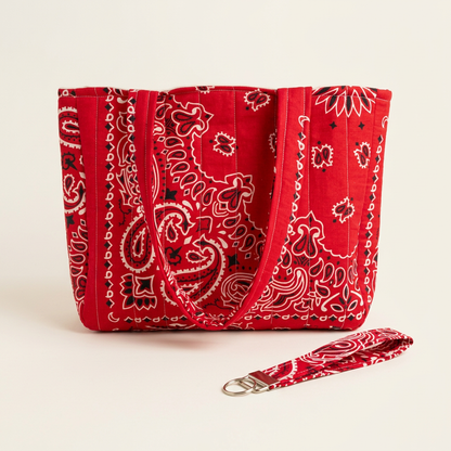 Red bandana quilted tote bag with matching wristlet keychain on a warm off-white background